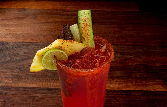 Clamato, topped with cucumber, pineapple, lime and meat stick
