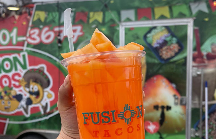 Melon Agua Fresca, held up and topped with fresh melon